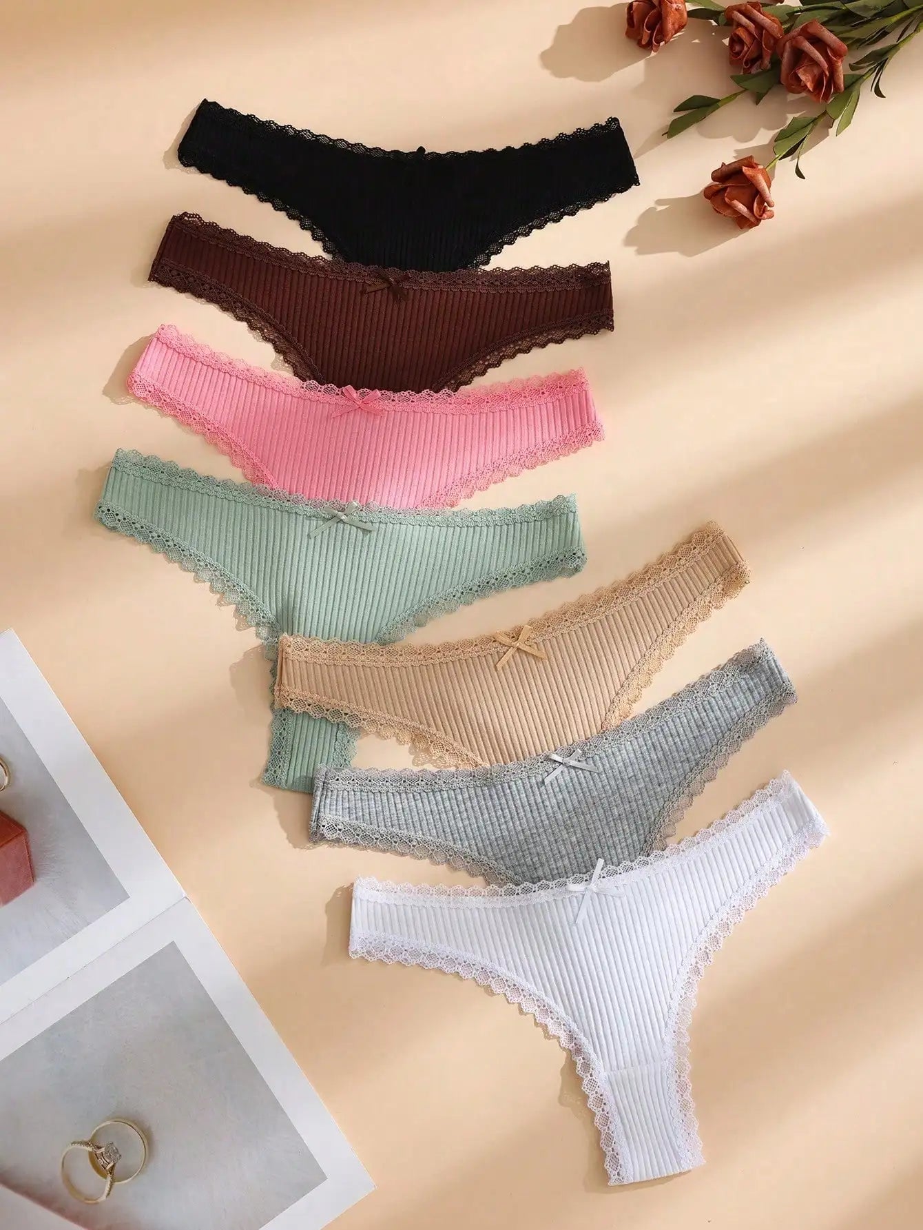 Random color 8-piece set of women's solid thin lace-trimmed thong panties, with cute little bows.